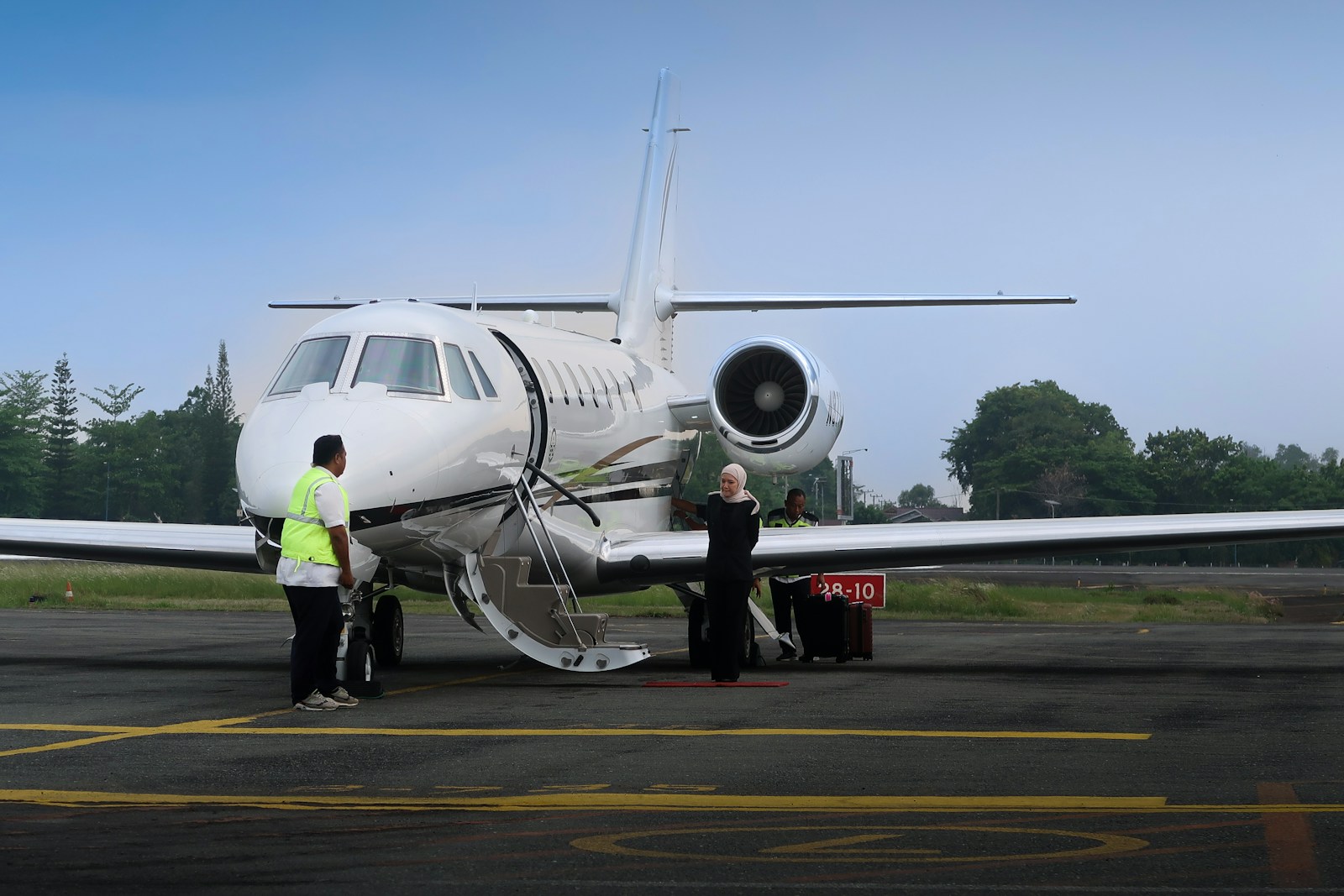 Halo Airways crew on the tarmac beside a private jet